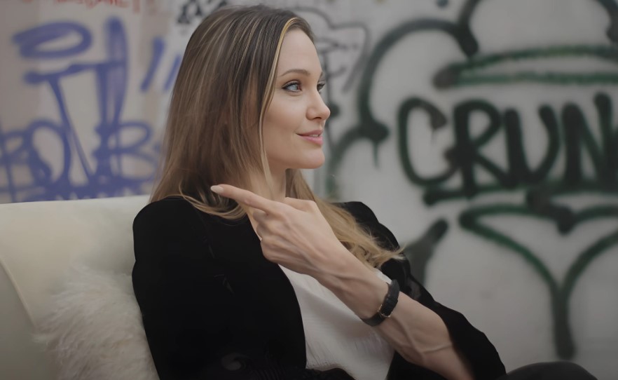 Angelina Jolie in a TV interview sitting on sofa