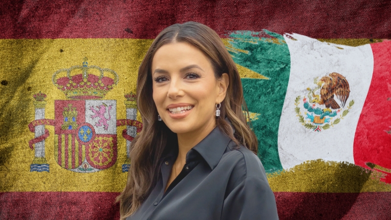 Eva Longoria smiles in front of the Spanish and Mexican flags