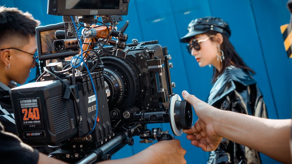Close-up of a professional film camera setup being operated by a crew on set