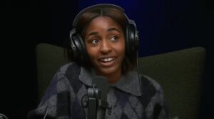 Ayo Edebiri talking during a live podcast show