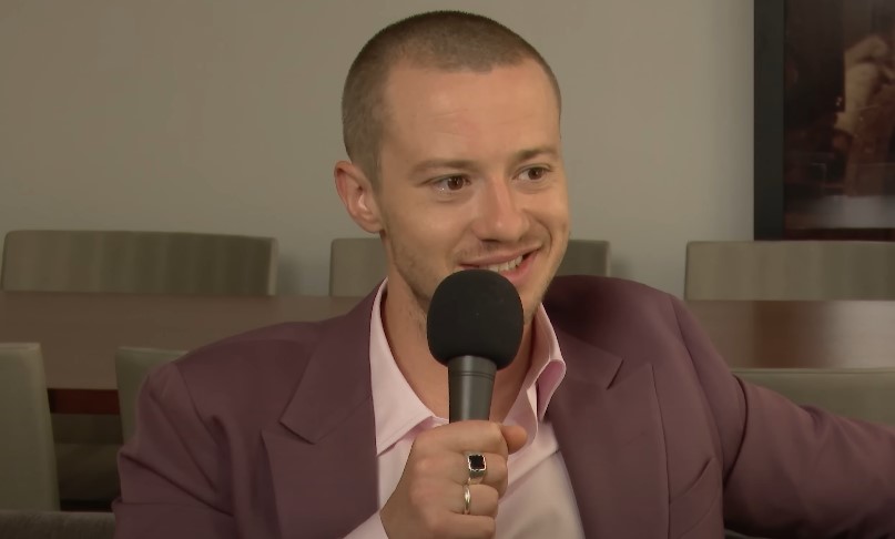 Joseph Quinn speaking during a TV interview